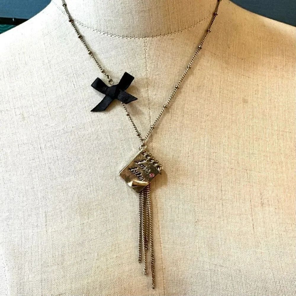 Gold tone love letters bow necklace